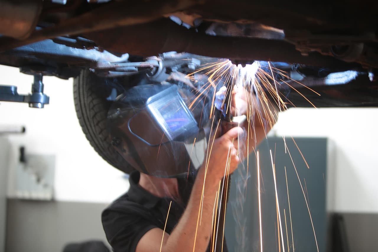 Sparks under a car on the lift